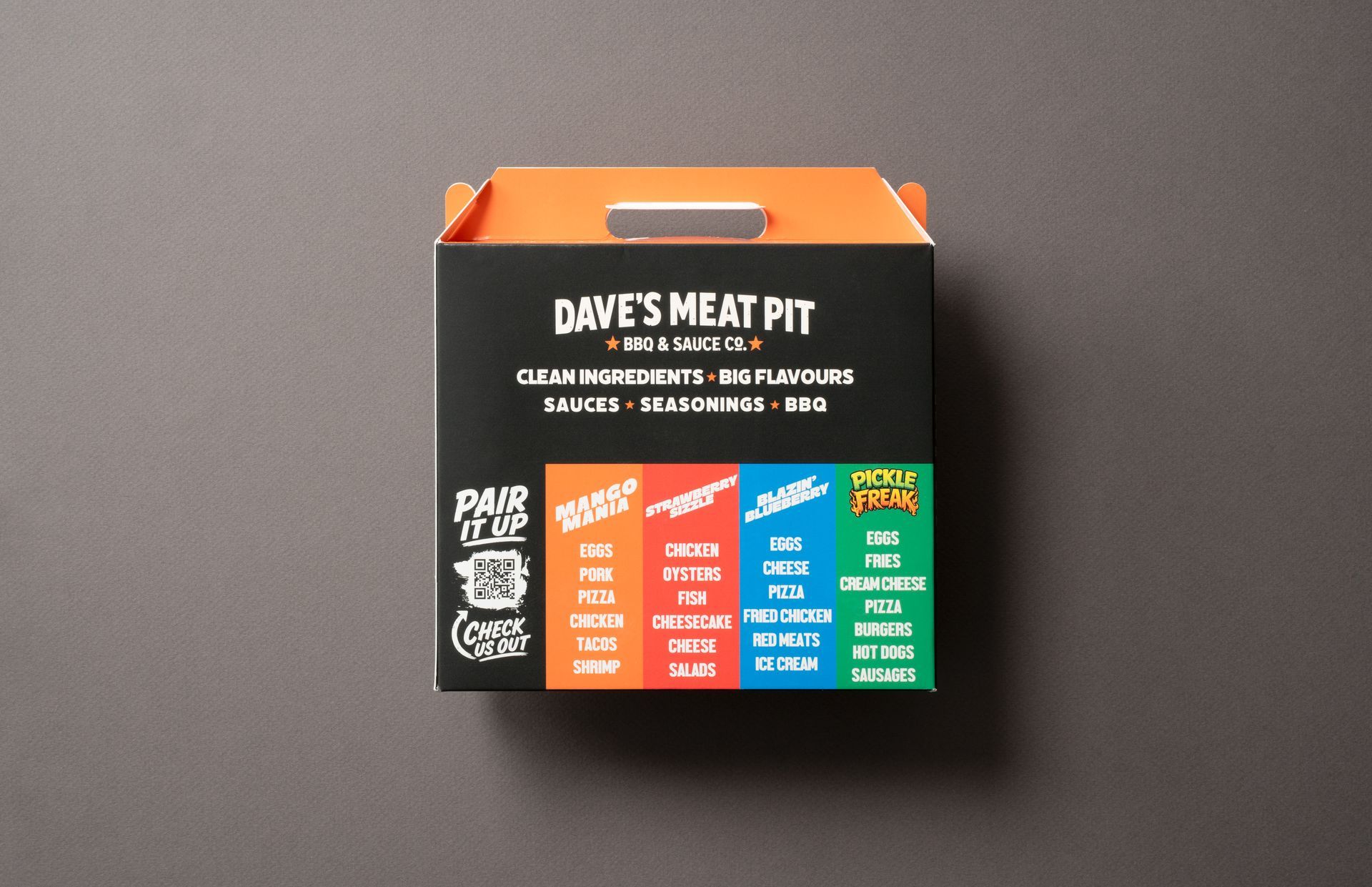 Dave’s Meat Pit takeout box on a gray background, black with orange and colorful menu panel.