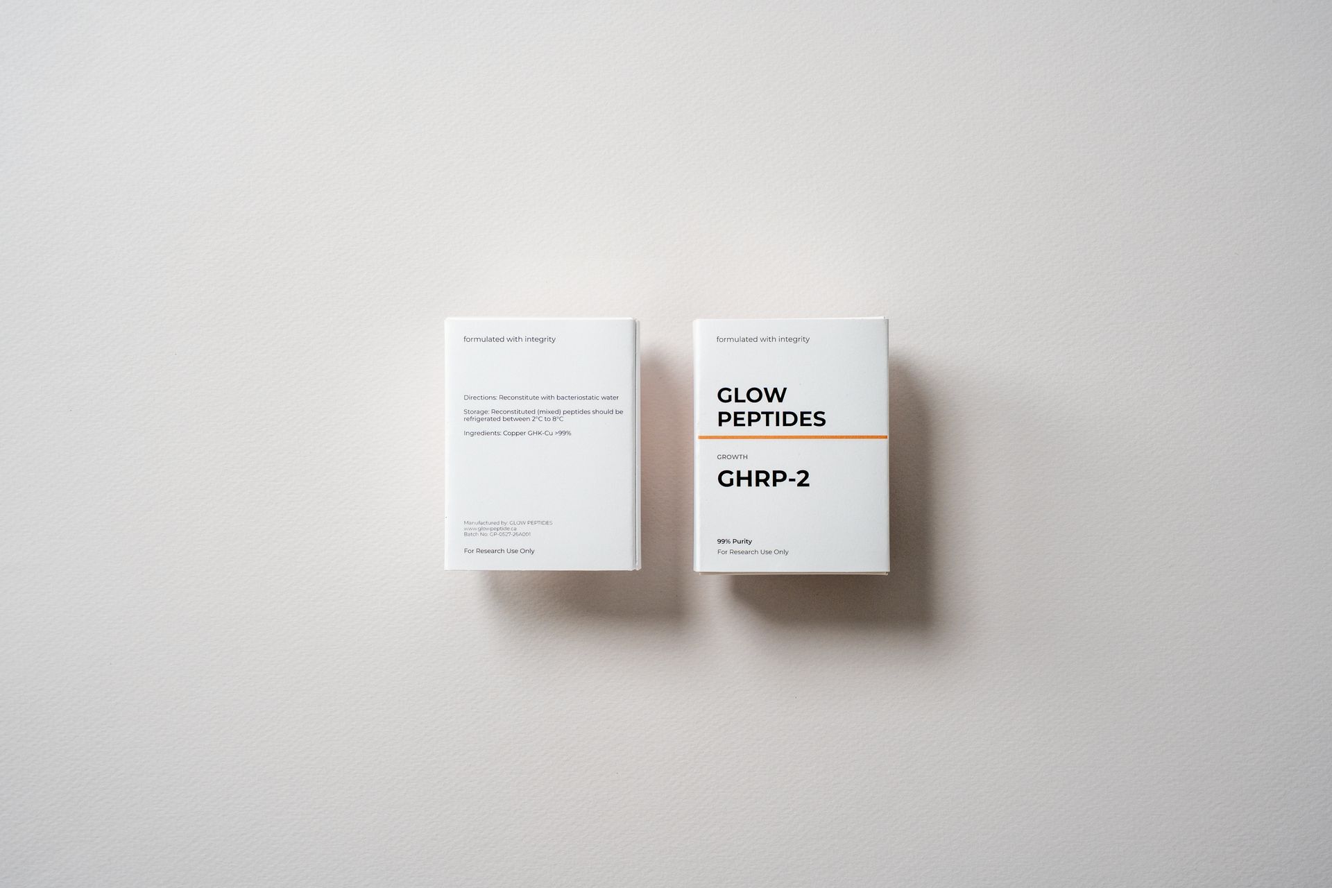 Two small white product boxes on a light gray surface, one labeled copper and one chip 2.