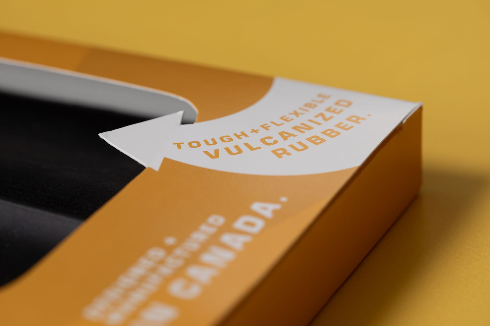 Orange and white cigarette pack with a warning label and a cigarette partially visible inside
