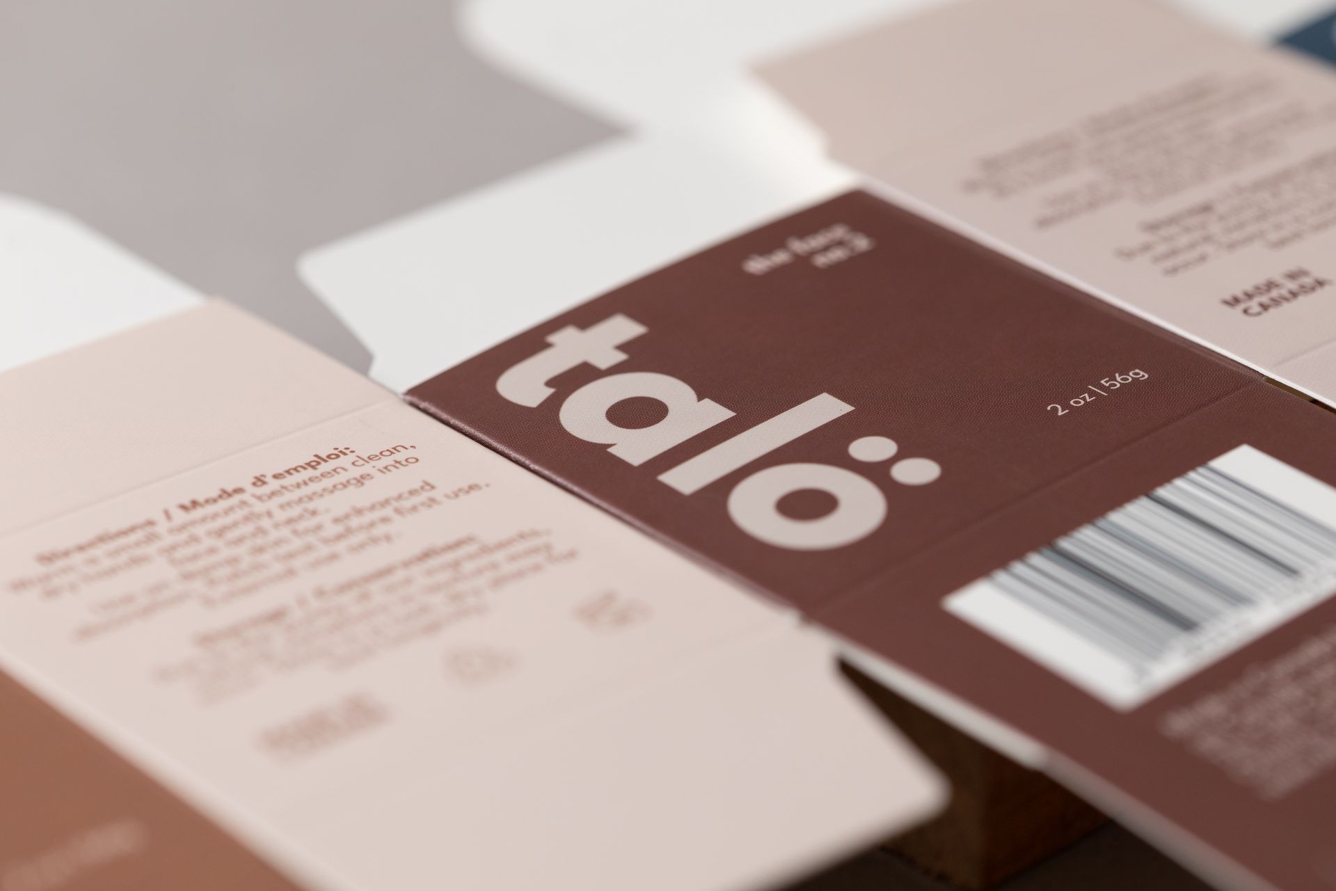 Close-up of a brown and white “talo” package with a barcode on a table.