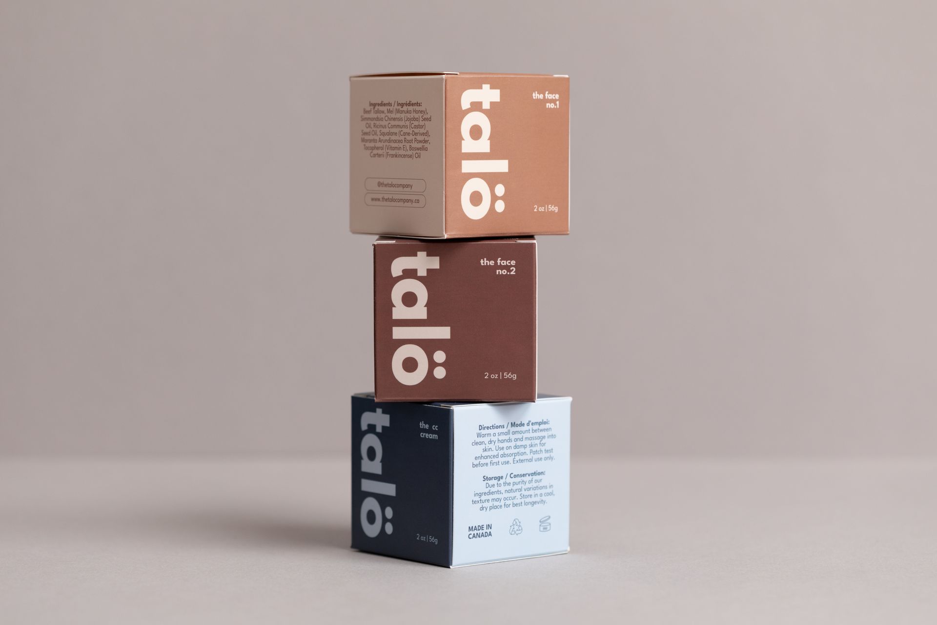Stacked Talo product boxes in tan, brown, and navy on a plain beige background