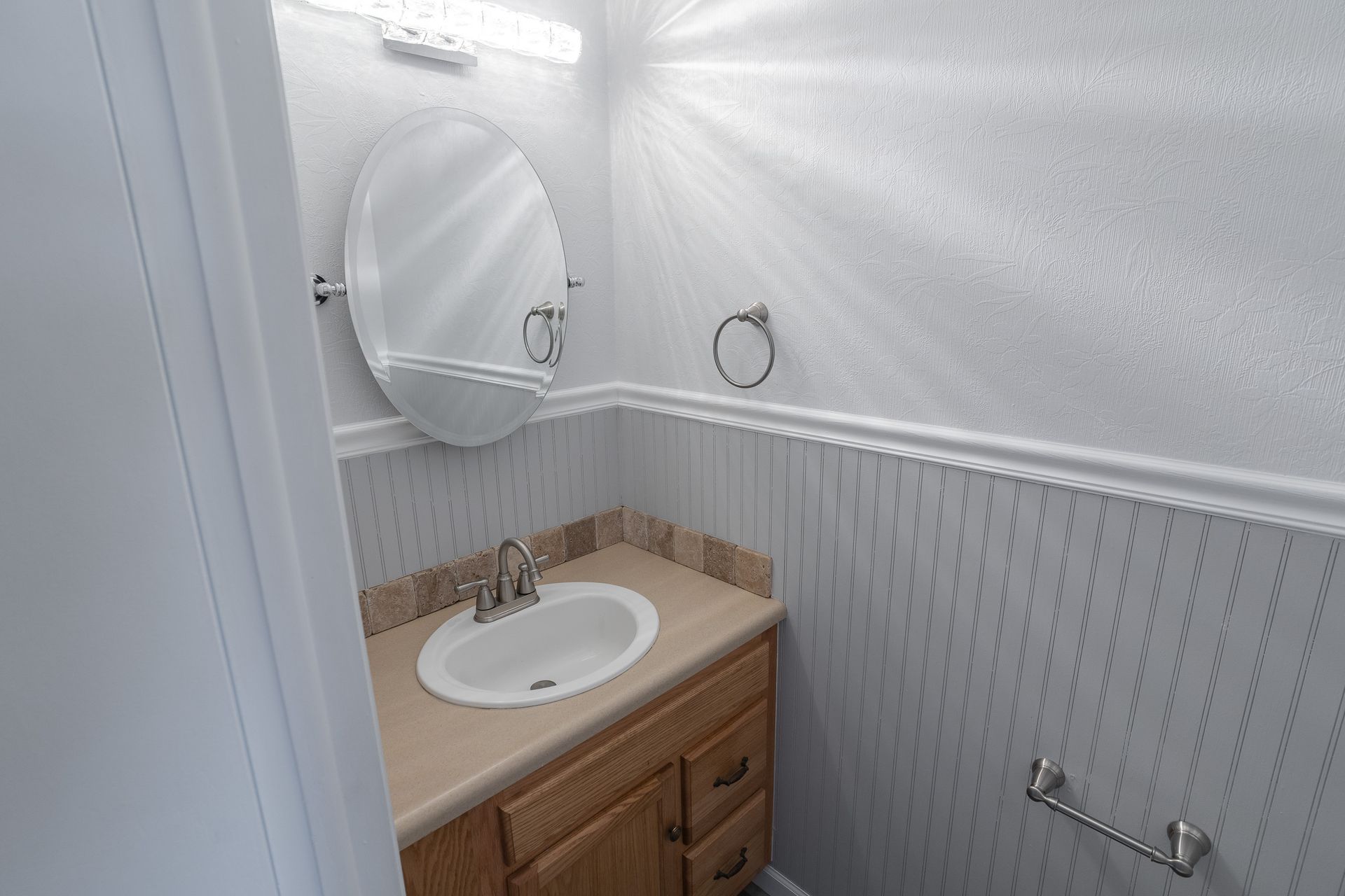 photo of a bathroom sink and vanity mirror