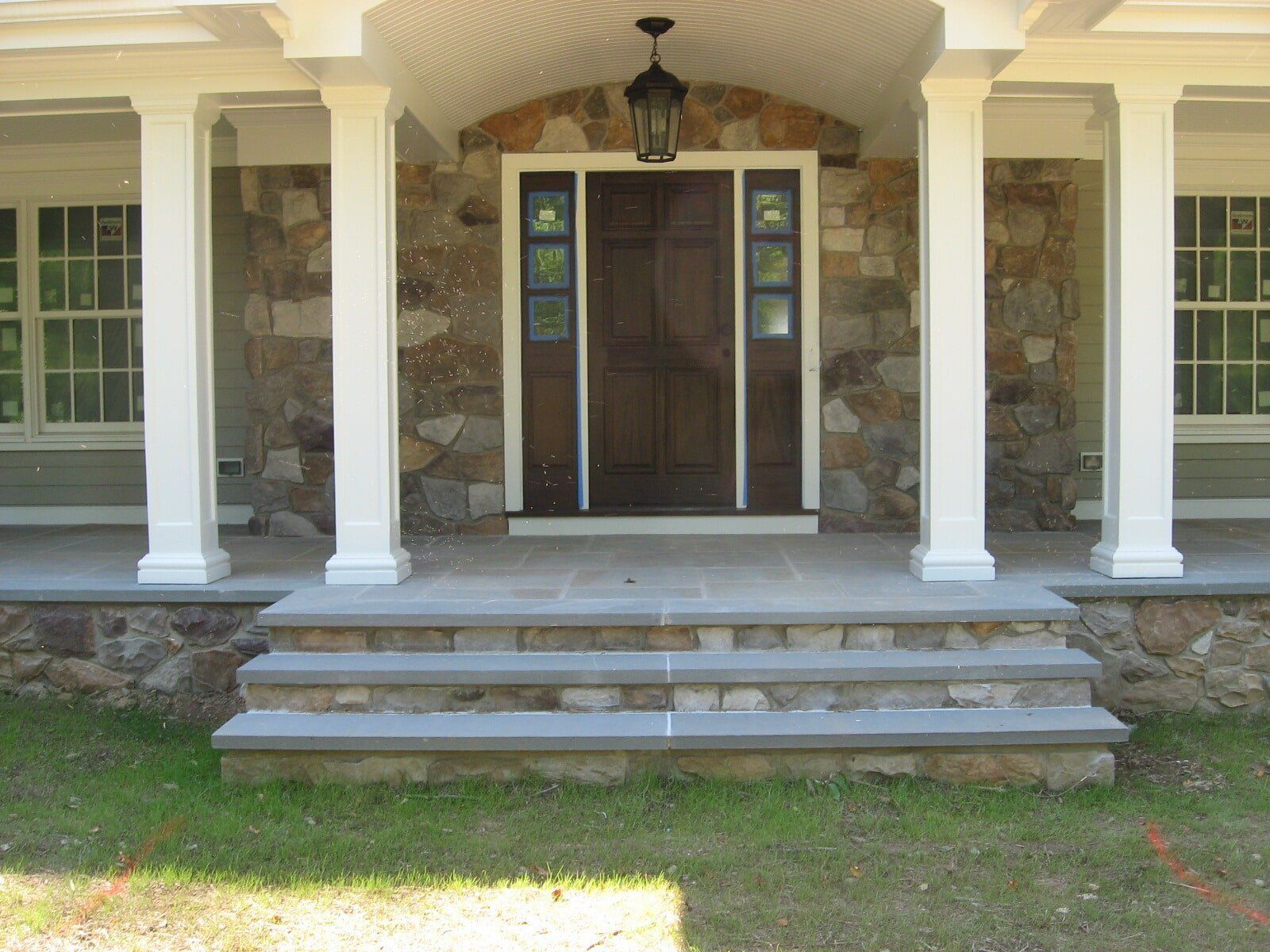 A Man Is Laying Bricks on A Brick Wall — Flemington, NJ — LaFerla Bros Inc. A Man Is Laying Bricks on A Brick Wall — Flemington, NJ — LaFerla Bros Inc.
