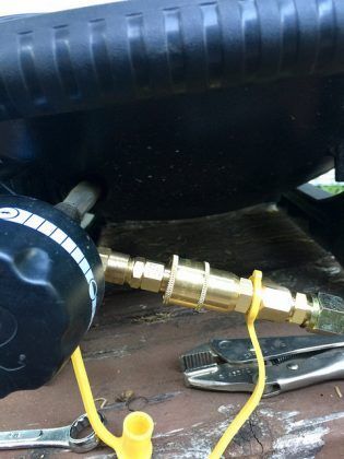 A close up of a hose attached to a tool on a table.