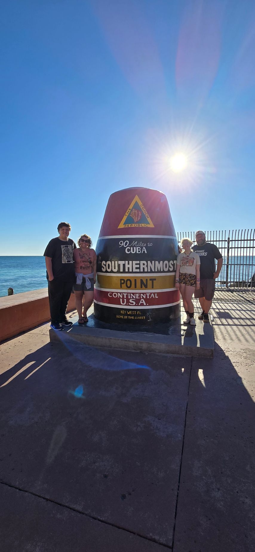 A group of people are standing in front of a large cone.