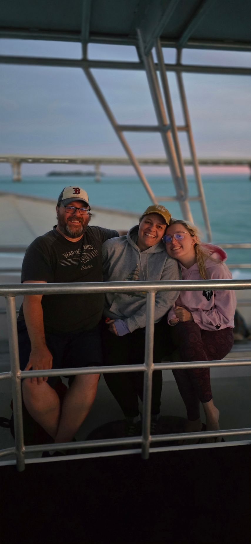 A group of people are posing for a picture on a boat.