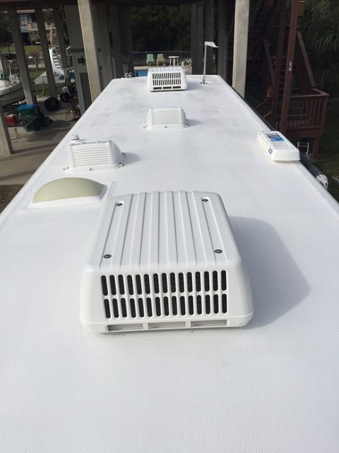 White RV roof with air conditioning units and vents.