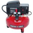 A red air compressor is sitting on top of a white surface.