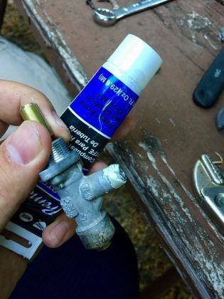 A person is holding a tube of blue paint