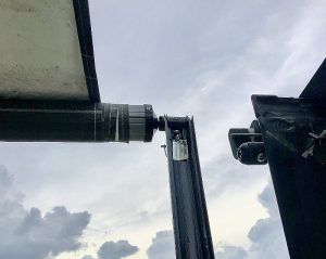 A close up of a piece of metal against a cloudy sky.