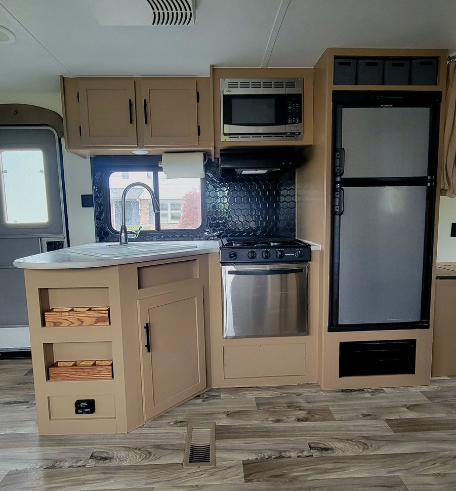 A kitchen with stainless steel appliances and wooden cabinets