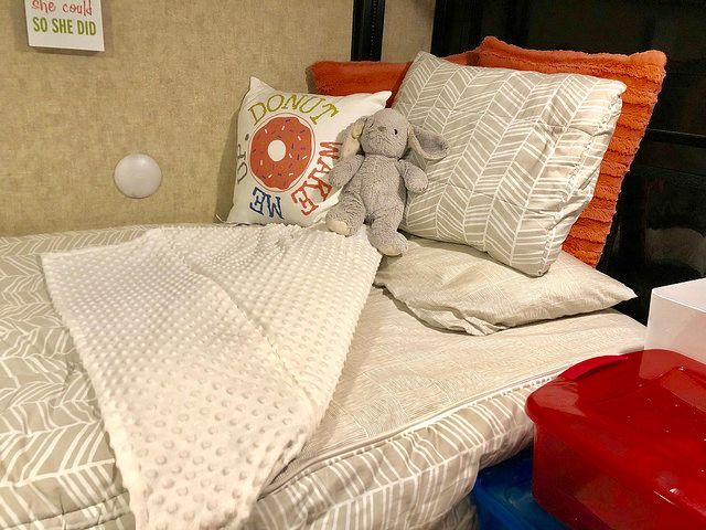 A bed with a pillow that says donut on it