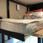 A bunk bed with a mattress and pillows on it.