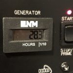 A close up of a digital timer on a generator.