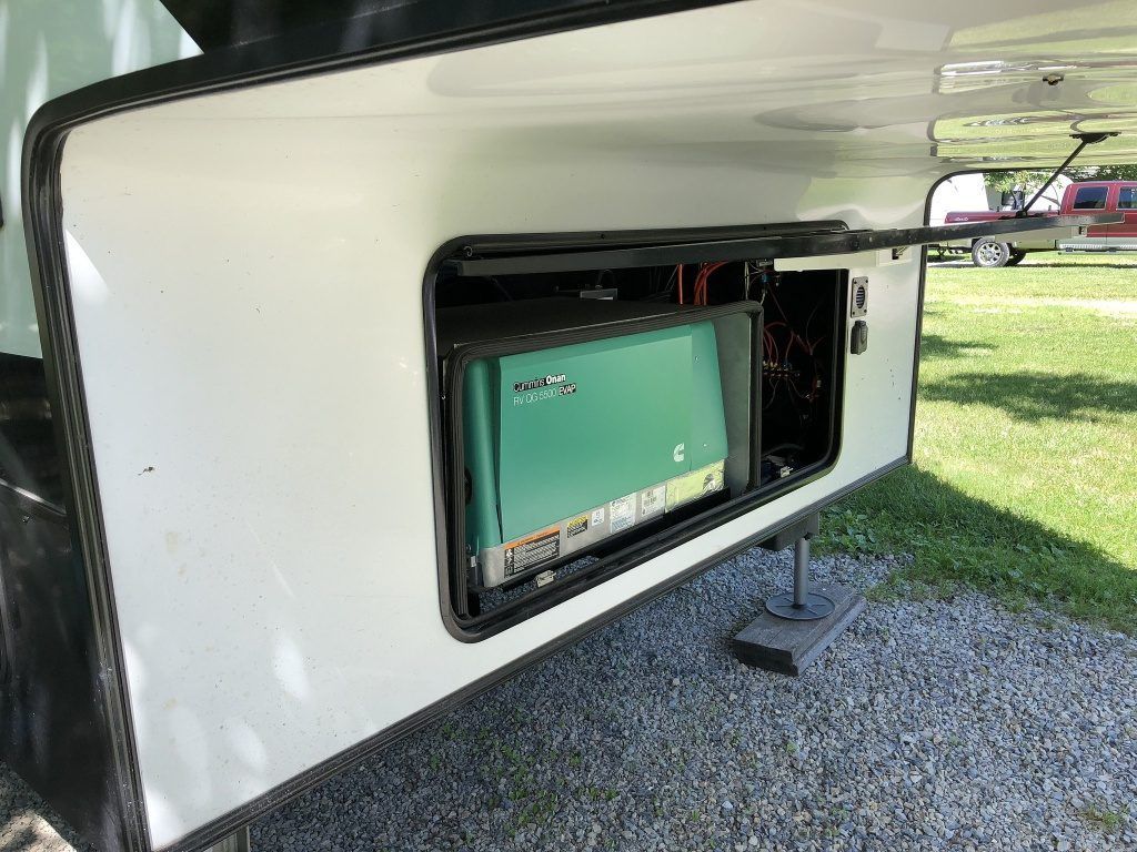 A rv with a green box in the back of it.