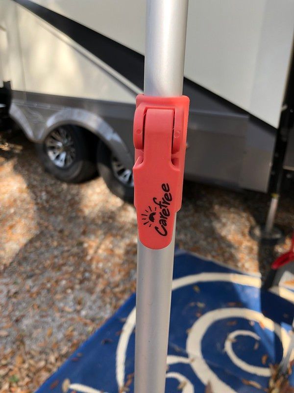 A camping pole with a red clip that says campfire on it