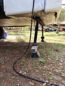 A hose is attached to the side of a trailer.