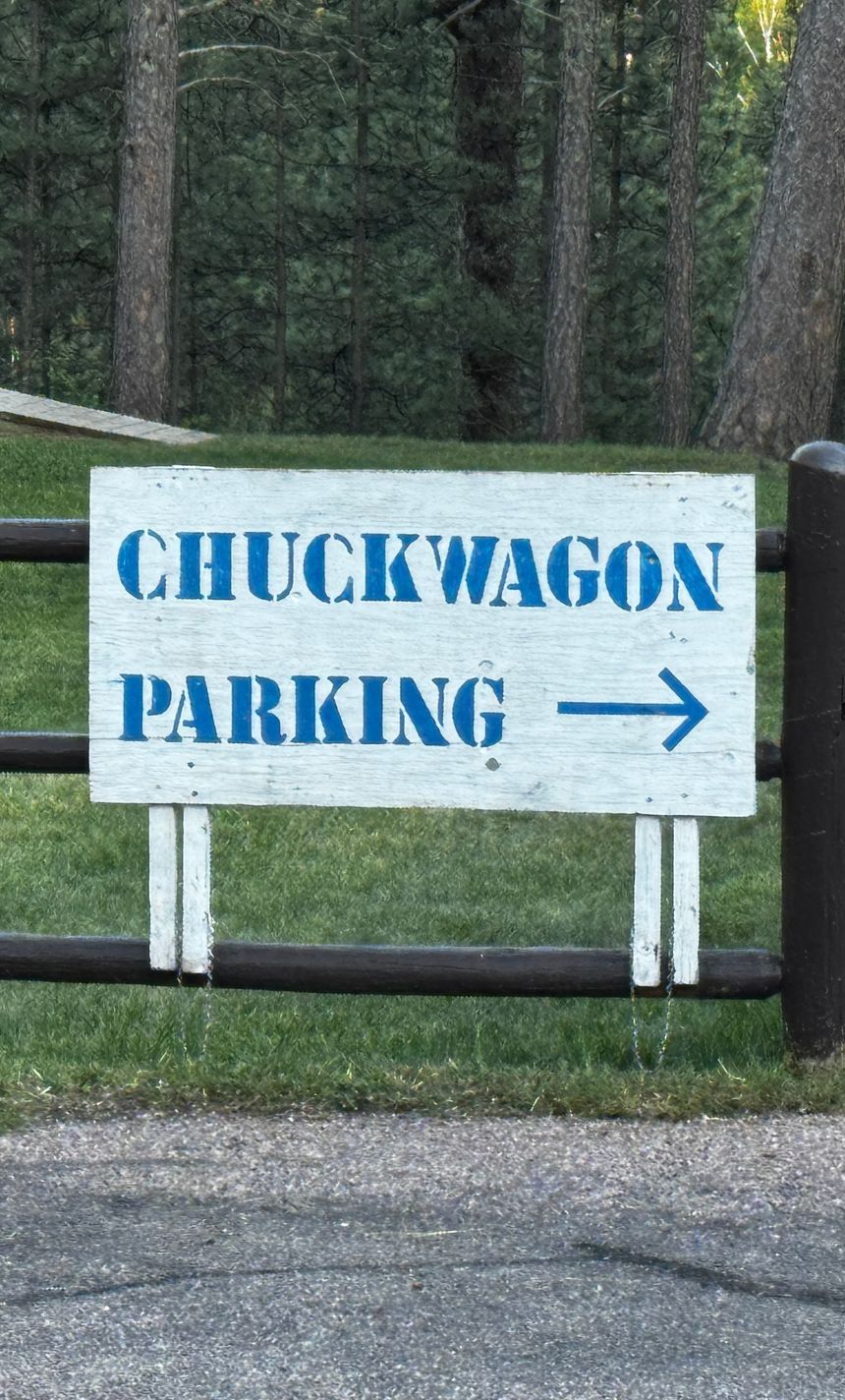 White sign on a fence: 