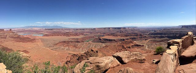 A panoramic view of a canyon with mountains in the background.