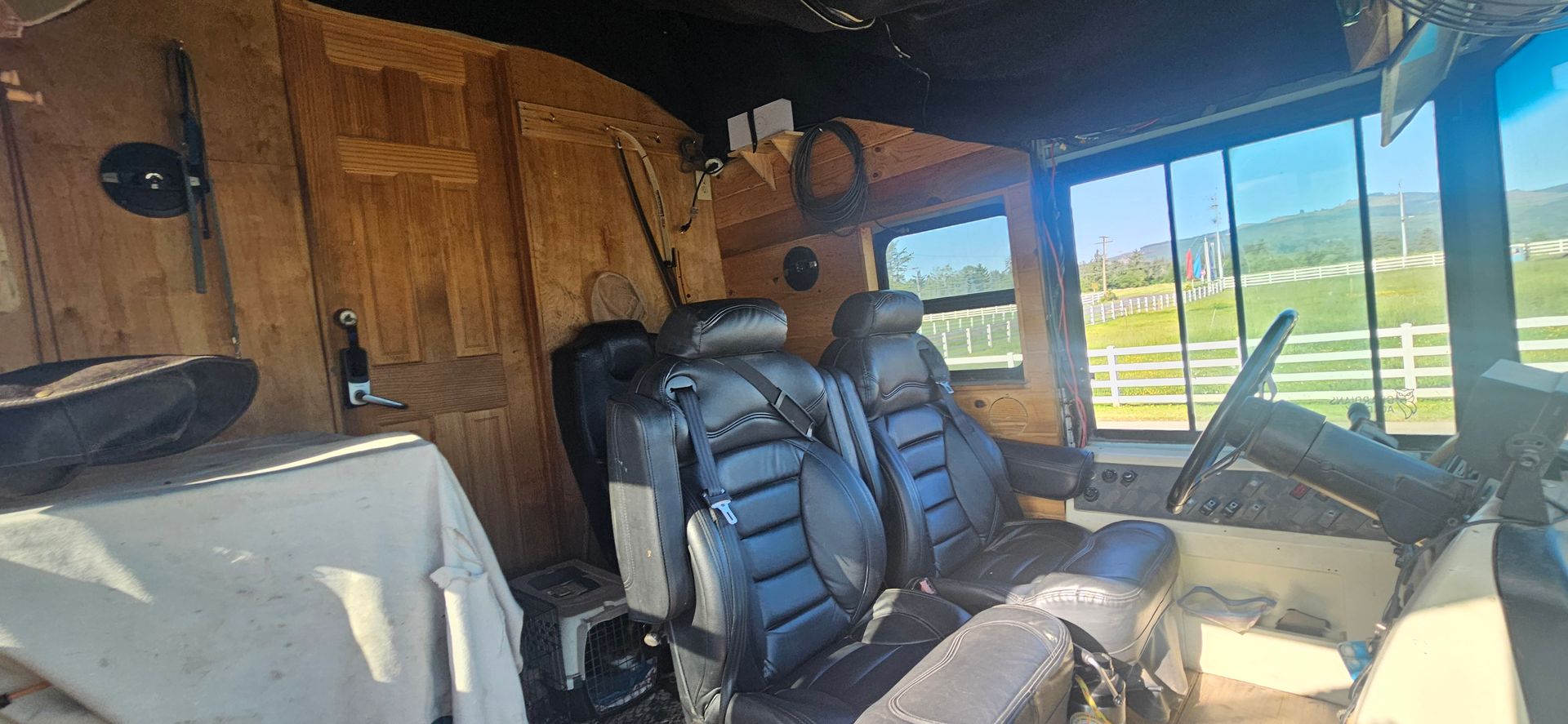 The inside of a vehicle with a steering wheel and seats.