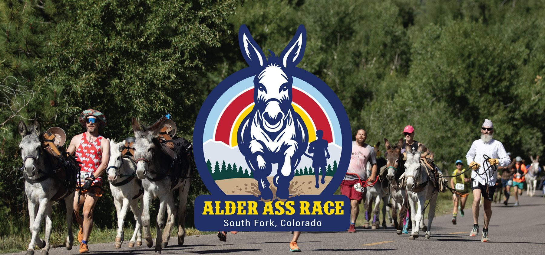 A group of people are running a race with donkeys.