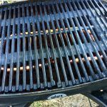 A close up of a grill with a lot of holes in it.