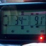 A person is holding a digital thermometer in their hand.
