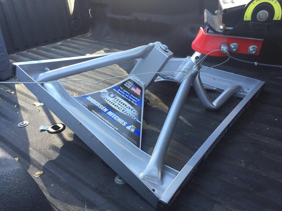 A trailer hitch is sitting in the back of a truck