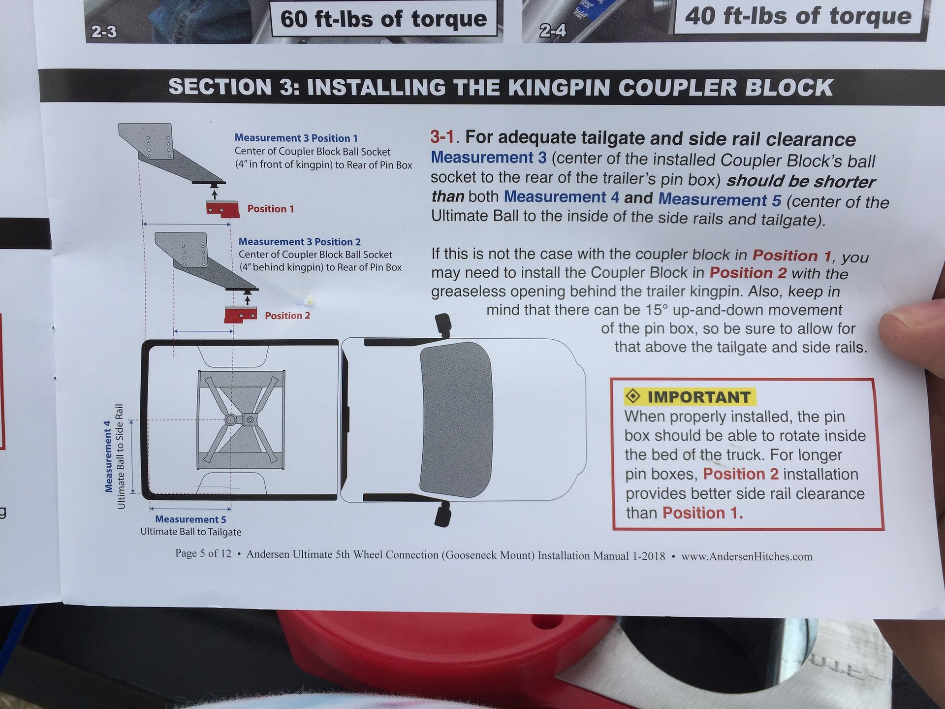 A person is holding a piece of paper that says section 3 installing the kingpin coupler block