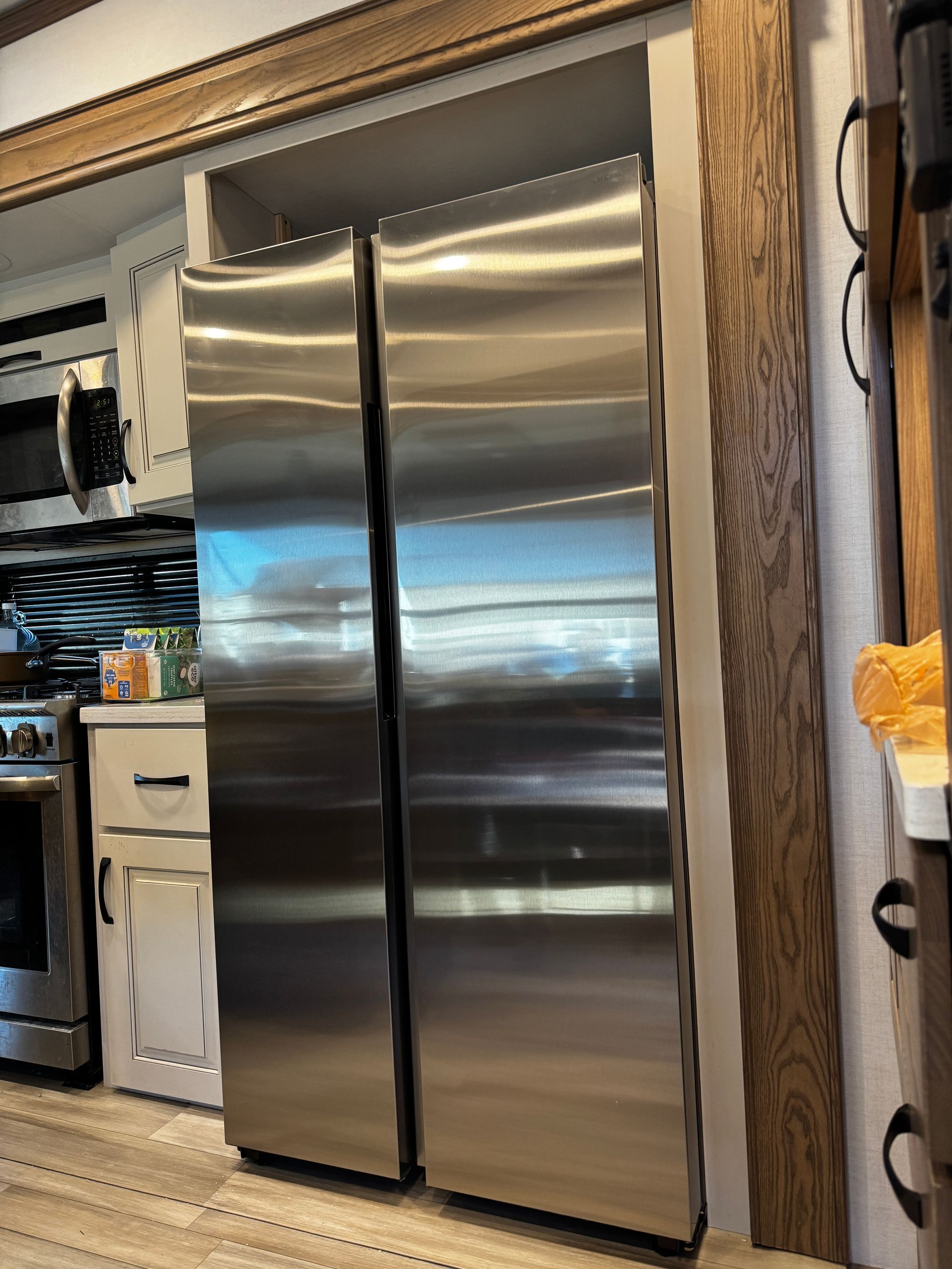 A kitchen with a stainless steel refrigerator and freezer.