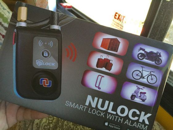 A person is holding a smart lock with alarm