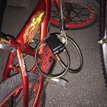 A red bicycle with a charger attached to it.