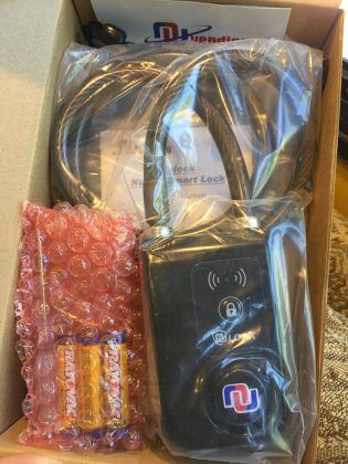 A box filled with a remote control and batteries.