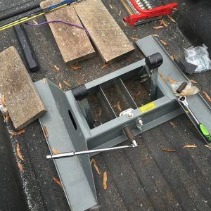 A tool is sitting on the back of a truck.