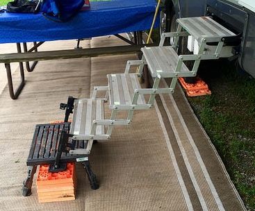 A set of stairs sitting on a rug next to a picnic table