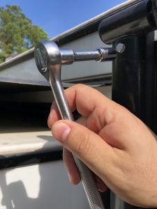 A person is holding a wrench in their hand.