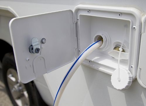 Open electrical panel with blue and white wires inside a white enclosure
