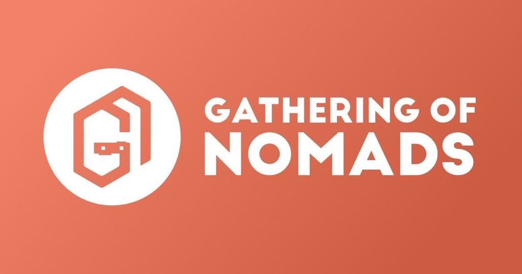 Logo for Gathering of Nomads, white hexagon and text on orange background.