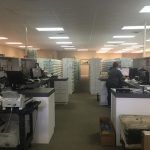A large office with a lot of people working in it.