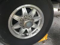 A close up of a car wheel with a tire on it.