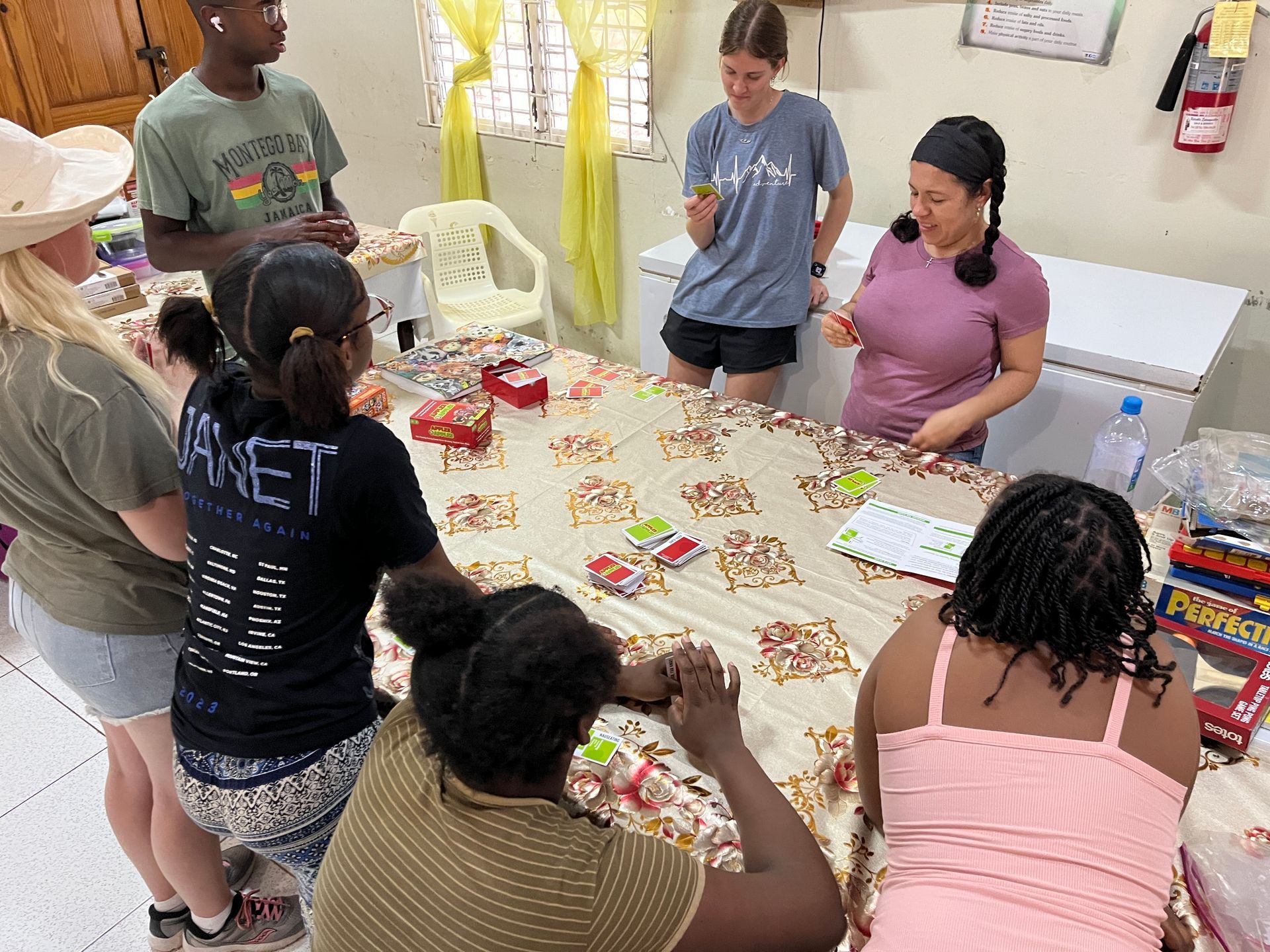 A group of people are sitting around a table playing a game.