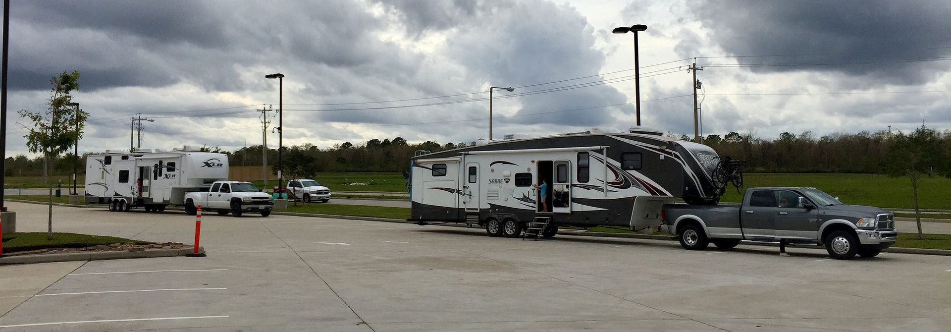 A rv is being towed by a truck in a parking lot