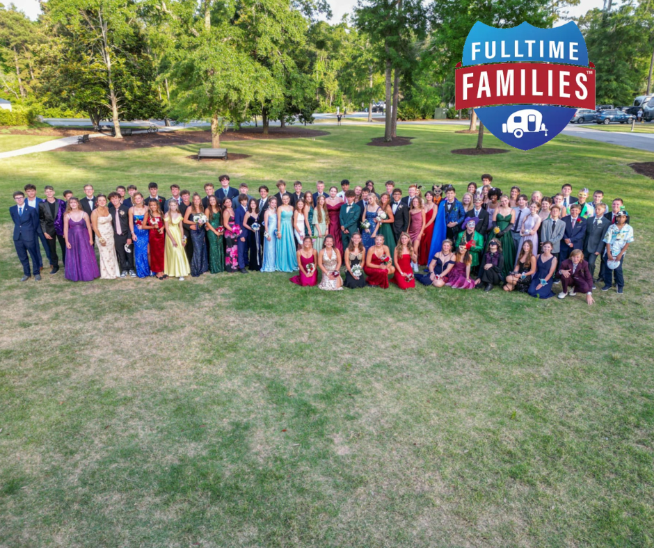 A large group of people posing for a picture with a fulltime families sign in the background