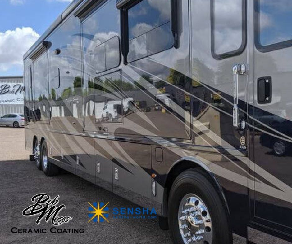 A large rv with ceramic coating is parked in a parking lot