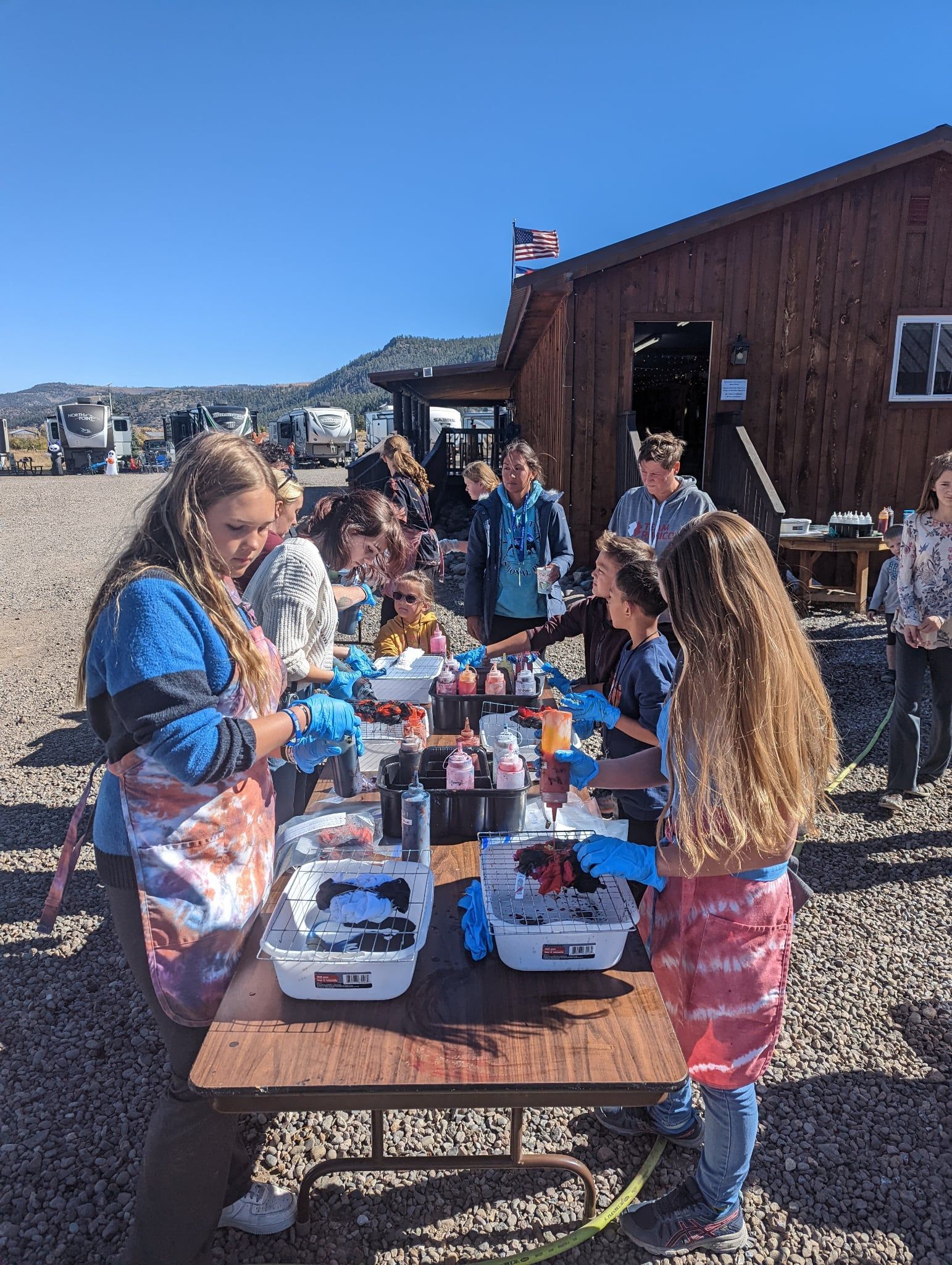 A group of people are standing around a table.