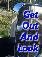A close up of a side view mirror with the words `` get out and look '' written on it.