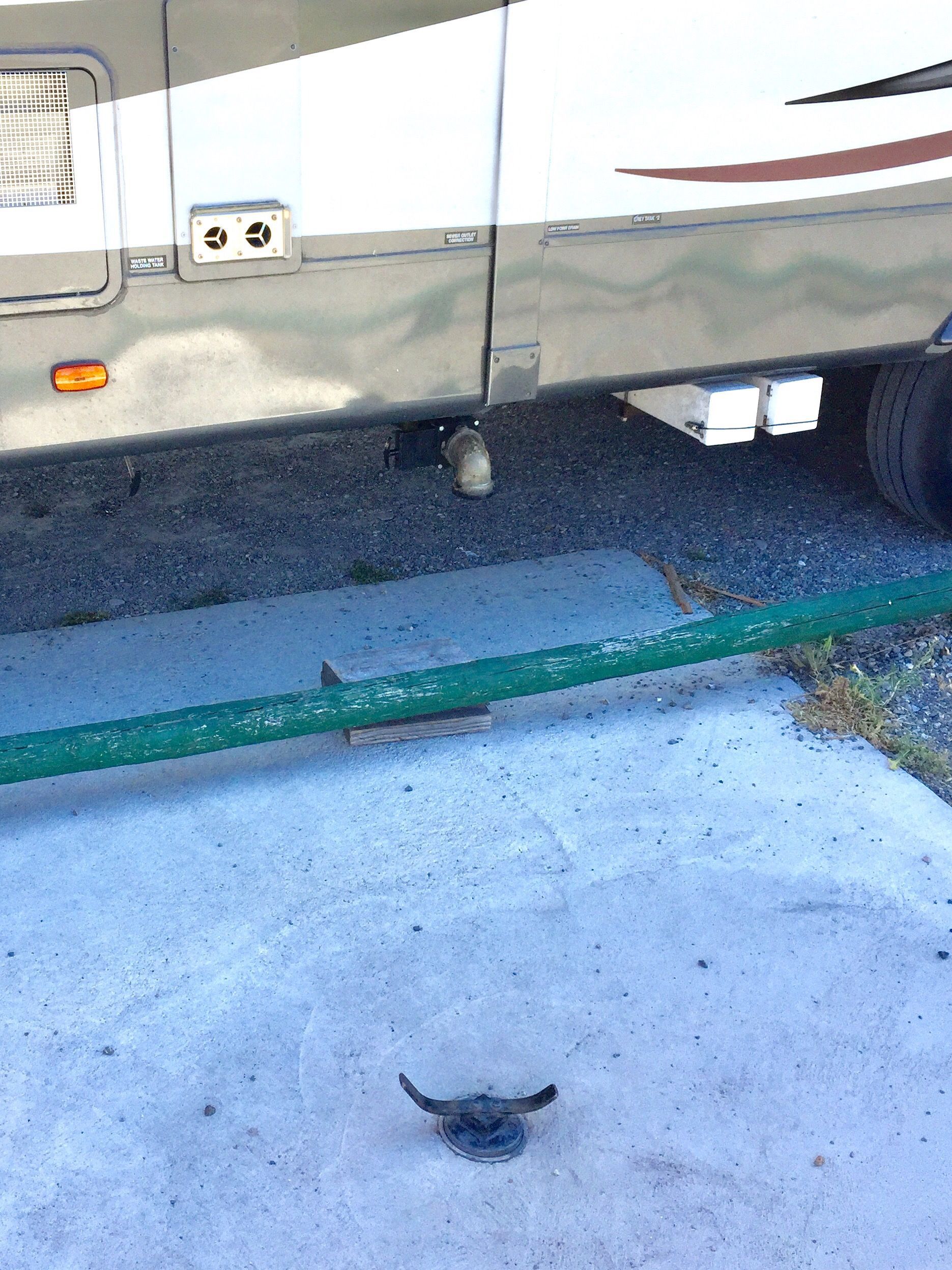 A hose is attached to the side of a rv.