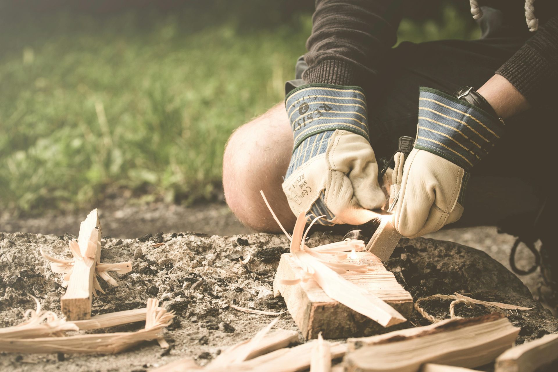 A person is lighting a fire with a flint and steel.