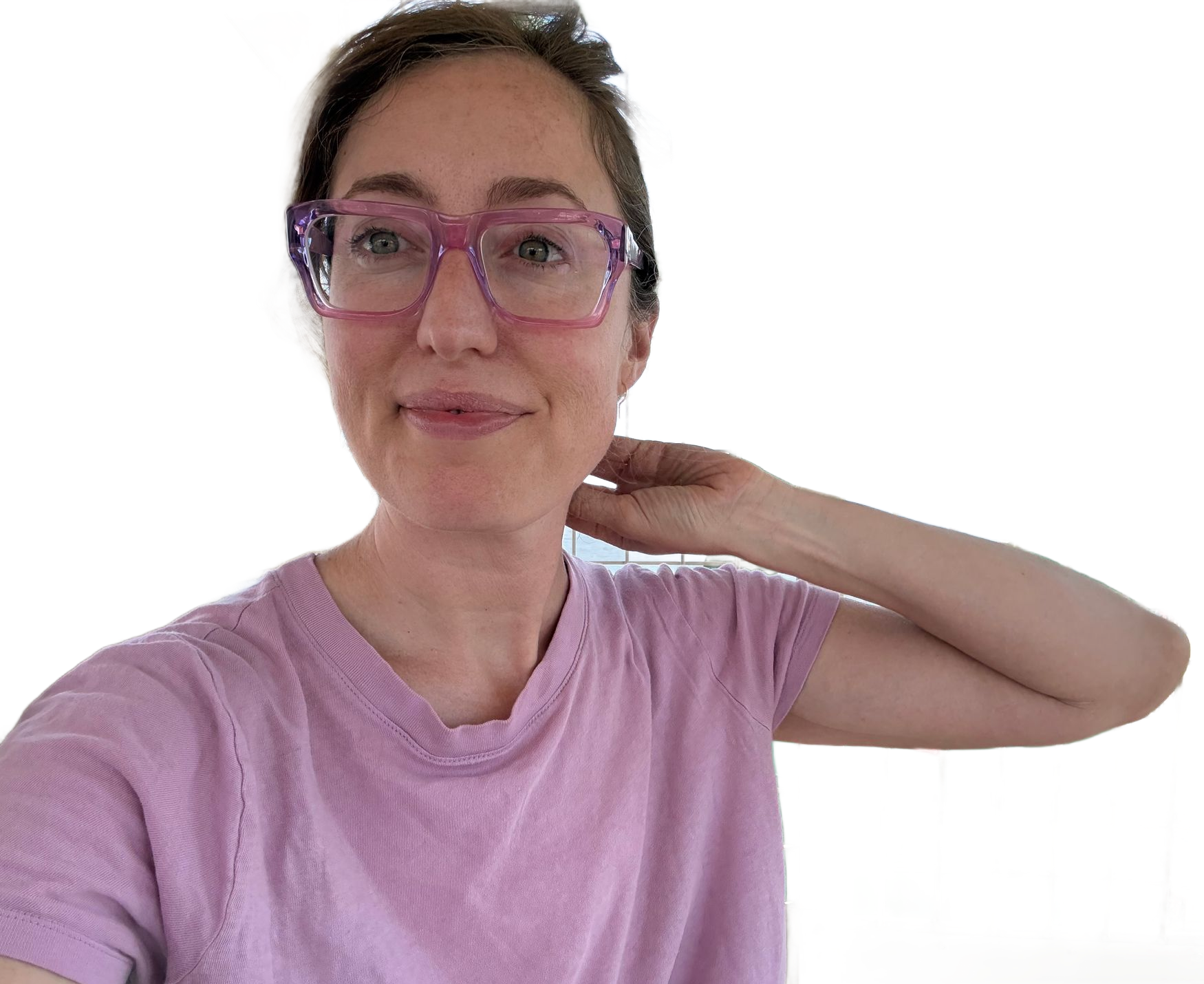 a candid portrait of Jenny outside, She is smiling, wearing a t-shirt and glasses.