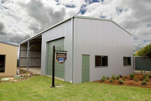 A Large Metal Structure With A Cloudy Sky In The Background — More Than Garages Pty Ltd–Ranbuild Tamworth in Taminda, NSW